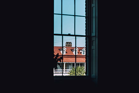 window near white house during daytime thumbnail