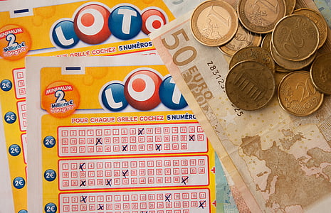 two yellow Lotto cards beside coins and banknote thumbnail