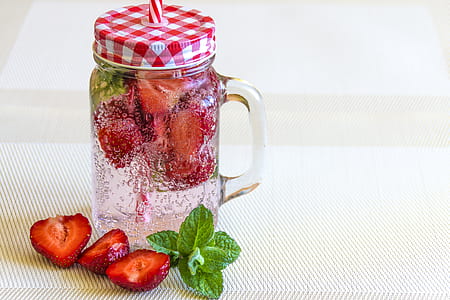 strawberries on clear glass mason jar thumbnail
