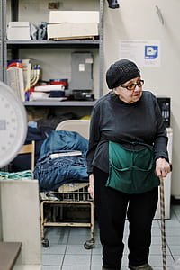 woman holding brown walking stick thumbnail