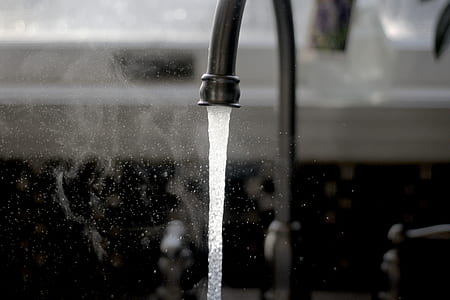 grayscale photo of water coming from faucet thumbnail
