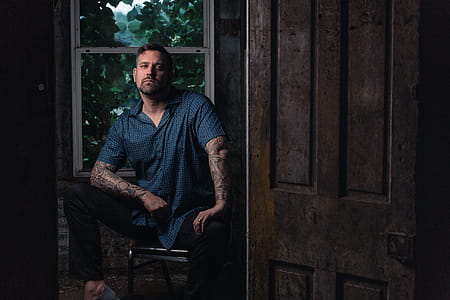 Man Sitting on Chair Near Clear Glass Window thumbnail