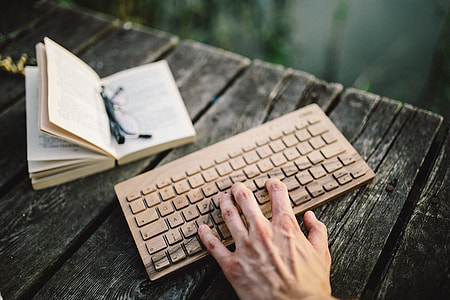 Male hand on the wooden keyboard thumbnail