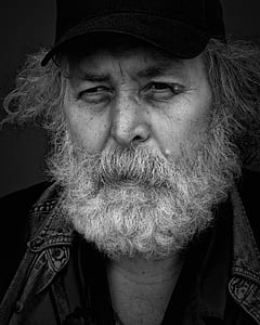 grayscale photo of bearded man wearing cap thumbnail