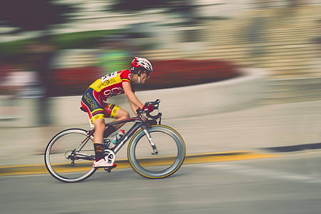 man in yellow and red on bicycle thumbnail