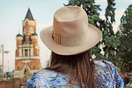 woman standing wearing brown bucket hat near tree thumbnail