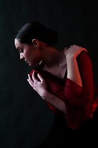 woman wearing red V-neck long-sleeved shirt with both hands on shoulder thumbnail
