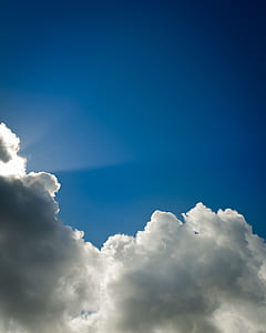 sun behind cumulus clouds thumbnail