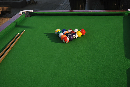 pool table with balls and cue sticks thumbnail