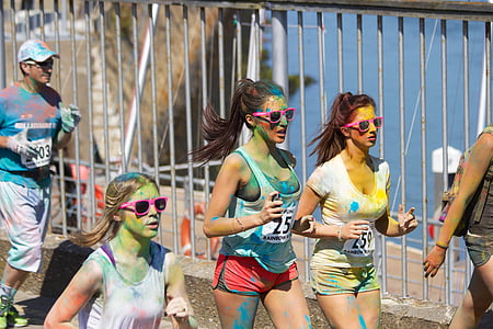 three women running near gray metal fence thumbnail