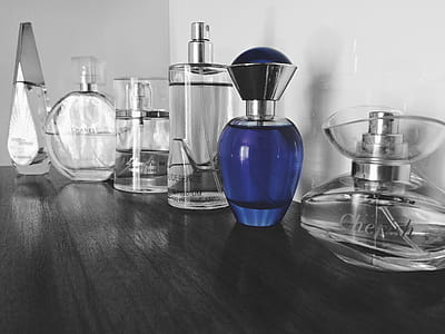 Selective Focus Photography of Blue Fragrance Bottles on Table thumbnail