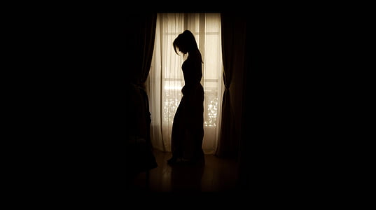 woman standing near window thumbnail