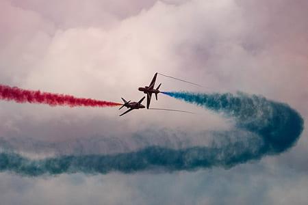 two red jet planes on air releasing blue and red smokes thumbnail