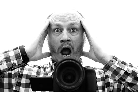 grayscale photo of man screaming with bridge camera in front thumbnail