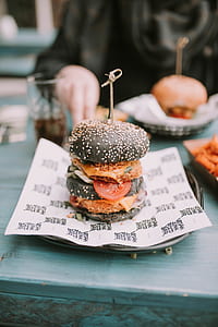 selective focus photography of black burger on plate thumbnail