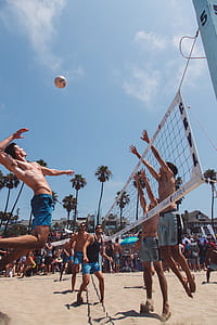 low angle of people playing volleyball near net thumbnail
