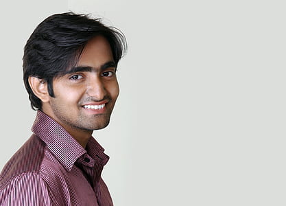 man standing near white wall thumbnail