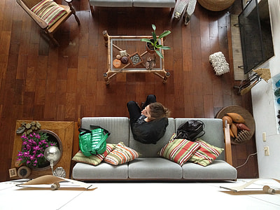 person sitting on gray 3-seat couch thumbnail
