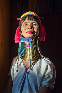 woman wearing white top wearing brass neck bangles thumbnail