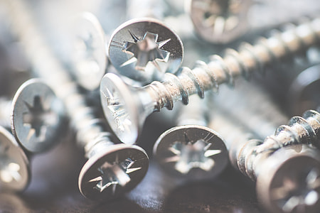 Pile of Silver Flat Crosshead Screws Close Up #1 thumbnail