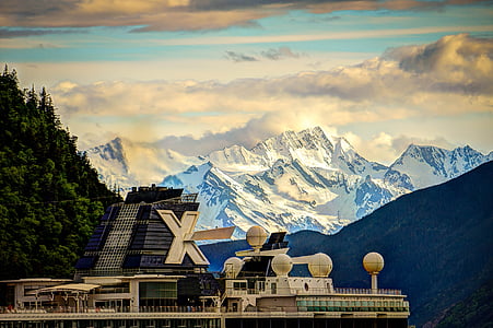 white building near trees and mountians thumbnail