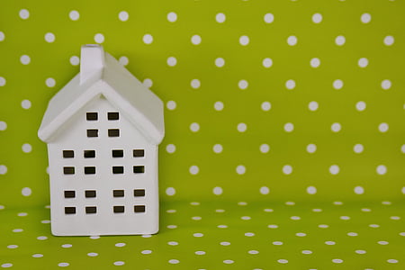 white house miniature beside lime-green and white polka-dot textile thumbnail