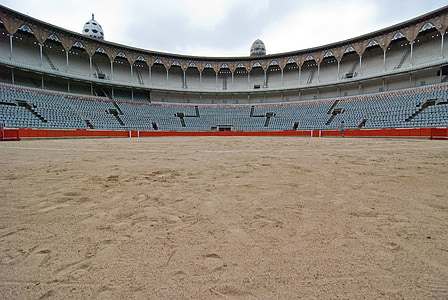 gray, blue, and red stadium under white clouds thumbnail