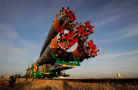 red, green, and black rocket on brown field at daytime thumbnail
