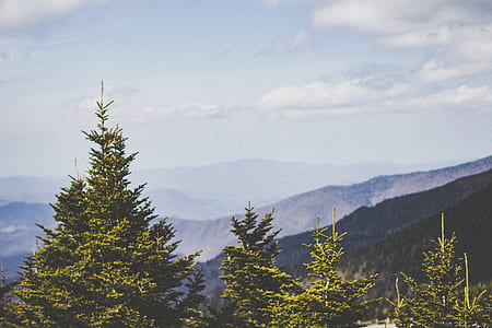 aerial photography of mountains under blue sky thumbnail