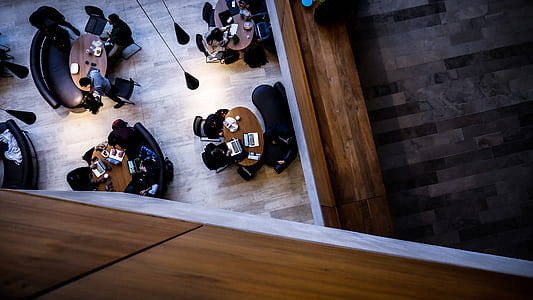 top-view photo of people doing task on tables thumbnail