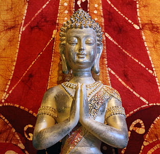 Gautama Buddha near red and orange wall thumbnail