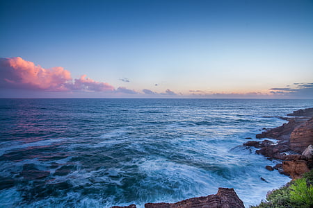 body of water near rocky cliff thumbnail