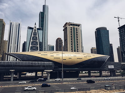 vehicle across near brown and black structure during daytime thumbnail