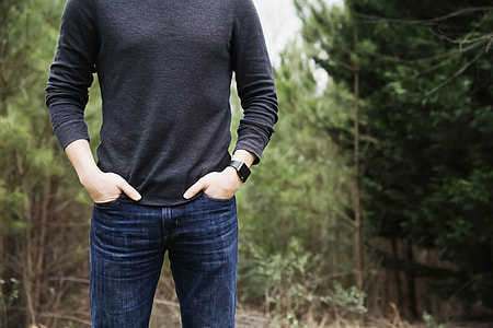 person wearing blue jeans standing on forest thumbnail