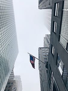 USA flag hanging on gray building thumbnail