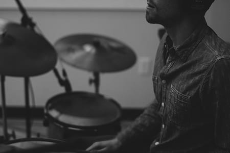 grayscale photo of man playing drums thumbnail