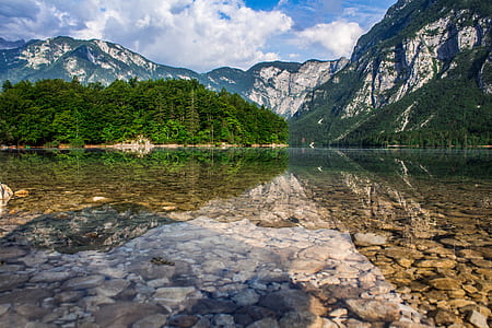white and green mountain under white and blue cloudy sky thumbnail