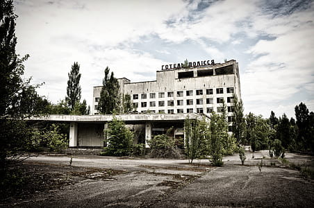 white concrete building surrounded by trees thumbnail