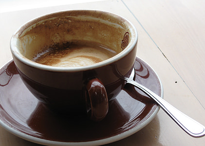 brown ceramic cup on saucer filled with coffee thumbnail