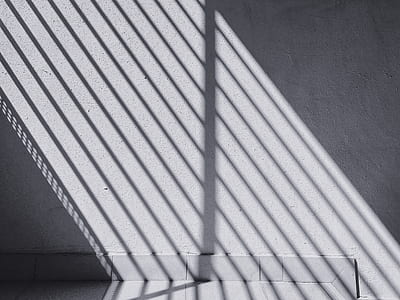 shadow of rail casting on gray wall thumbnail