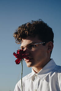 man smelling red rose thumbnail