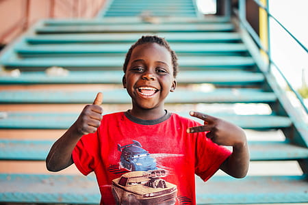 boy wearing red Cars crew-neck t-shirt at the back of blue stairs thumbnail