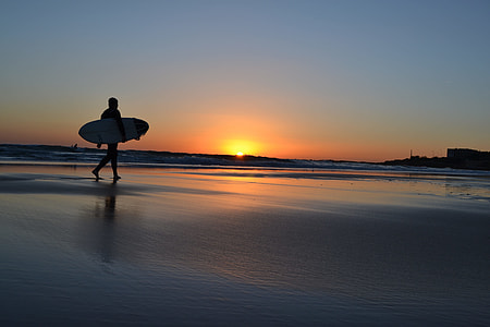 silhouette of person holding  board during sunset thumbnail
