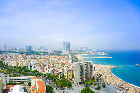 aerial photo of buildings near body of water during daytime thumbnail