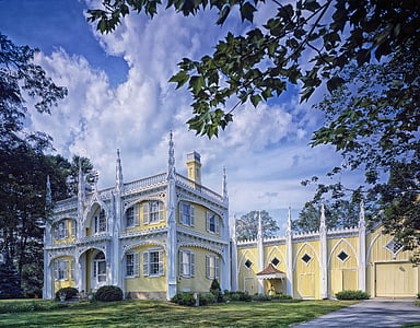 yellow and white painted building near trees thumbnail