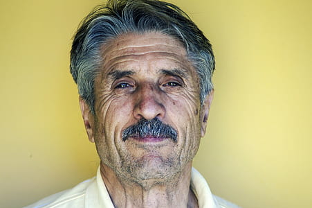 man wearing white collard top thumbnail