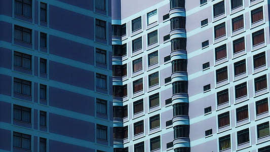 optical illusion photograpy of two blue high-rise buildings thumbnail