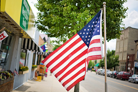 USA flag rising near the building thumbnail