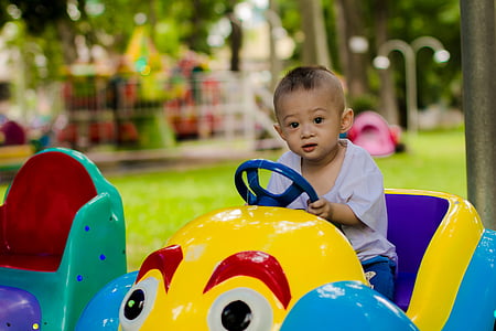 child rides yellow and purple car toy thumbnail