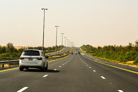 silver vehicle crossing road at daytime thumbnail